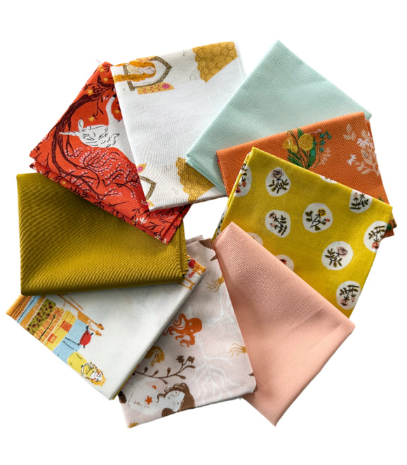Collection of colorful Heather Ross quilting fabric fat quarters with various patterns on a light gray background