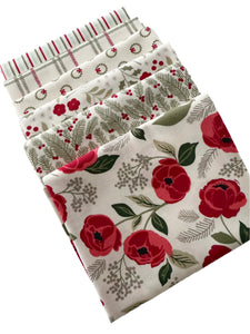 Set of fat quarters from Lella Boutique Christmas collections with floral and winter-themed patterns on a light background