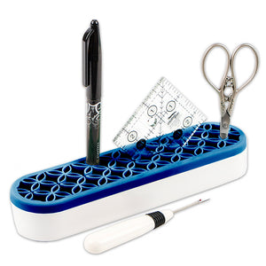 Stash n Store is an elongated oval shape.  It has a white plastic bottom and a navy silicone top with flexible grooves that hold sewing supplies.