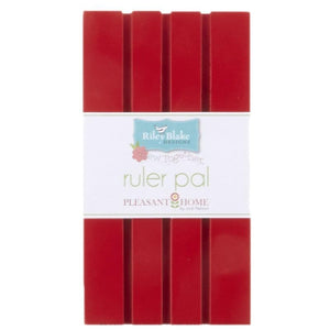 Ruler pal is a piece of painted wood with shallow grooves made for holding quilting rulers.  Red Color. Designed by Pleasant Home for Riley Blake Designs.